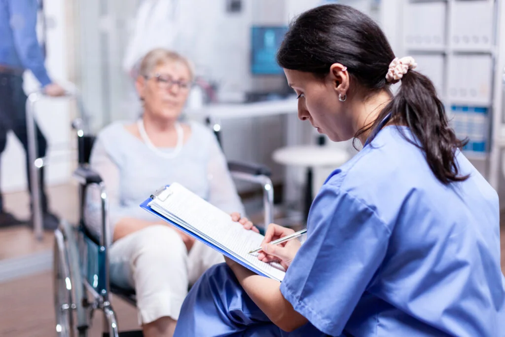 Nurse supporting an older patient